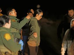 La Patrulla Fronteriza de Estados Unidos revisa a una migrante cerca de la valla fronteriza entre Estados Unidos y México. AFP